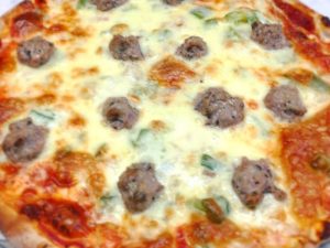 Experience River Falls Locally Loved - Close up of pizza from Steve's Pizza